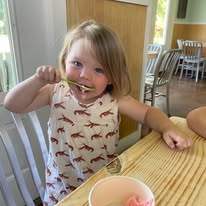 Happy customer enjoying stuffed snoball at North Shore Ice Co. Mandeville